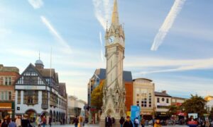 Clock tower with people in urban square