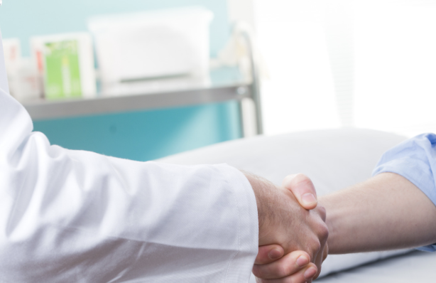 Doctor shaking hands with patient in clinic