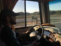 Driver in large vehicle with road ahead